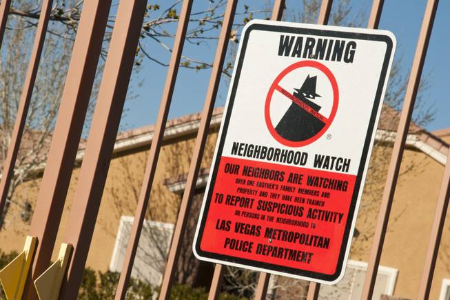 A Neighborhood Watch sign is posted at the entrance to a gated community to show their concern in keeping a safe neighborhood, Tues March 15th, 2011